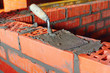 Foto: Puddle on brick with cement, bricklayer Puddle on brick with cement, bricklayer