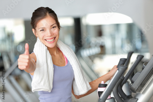 Photo: Happy fitness woman thumbs up in gym Happy fitness woman thumbs up in gym