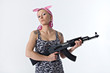 Young woman with automatic rifle