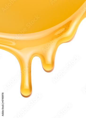 Photo: honey flowing on a white background honey flowing on a white background