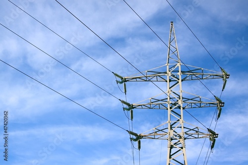 Photo: Electricity pylon against blue cloudy sky Electricity pylon against blue cloudy sky