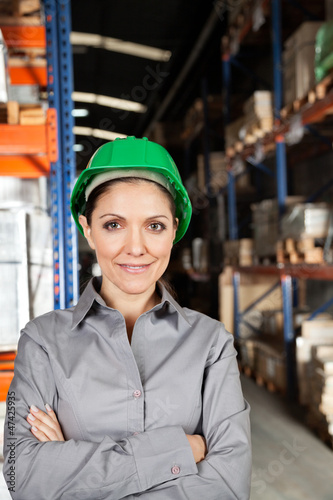 Photo: Female Supervisor With Arms Crossed At Warehouse Female Supervisor With Arms Crossed At Warehouse