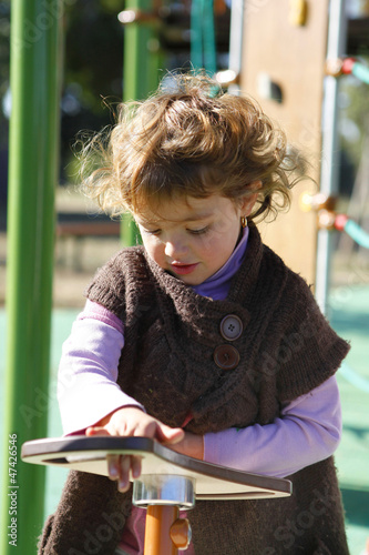 Photo: Young girl playing in a playground Young girl playing in a playground