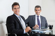 Businessmen Using Digital Tablet In Office
