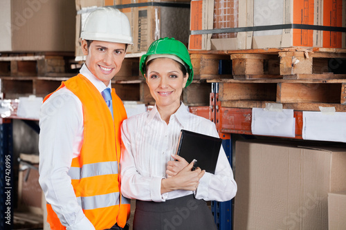 Photo: Confident Young Supervisors At Warehouse Confident Young Supervisors At Warehouse