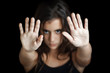 Hispanic girl signaling to stop isolated on black