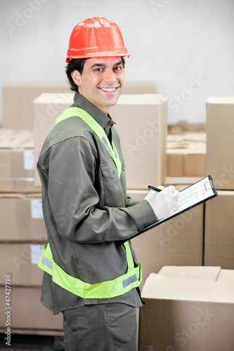 Photo: Supervisor Writing Notes At Warehouse Supervisor Writing Notes At Warehouse