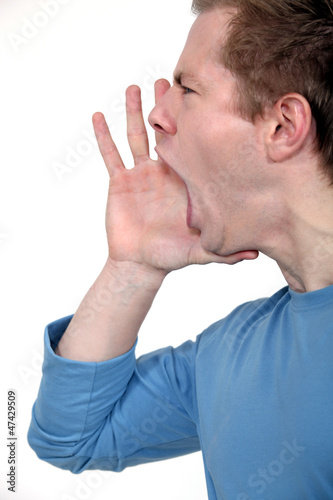 Photo: young man in profile shouting young man in profile shouting