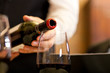 Waiter serving red wine with bottle at the restaurant