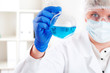 female chemist mixing liquids in test tubes