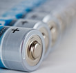 Several AA batteries in perspective closeup view on white