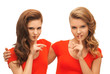 two teenage girls showing hush gesture