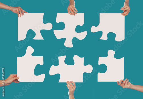 Photo: Hands and puzzle Hands and puzzle