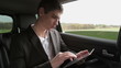 Young businessman with tablet computer in car