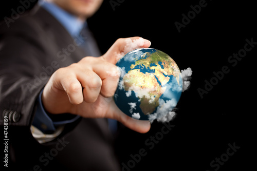 Photo: Businessman holding the world Businessman holding the world