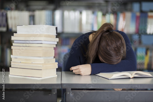 Photo: Female college student tired from studying Female college student tired from studying
