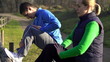 Young joggers stretching outdoors, super slow motion