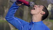Man drinking water after jogging