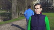 Portrait of young female jogger in park, crane shot