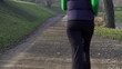 Woman jogging in park, crane shot, super slow motion