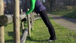 Video: Woman exercising, man jogging in park, crane shot Woman exercising, man jogging in park, crane shot