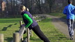Video: Woman exercising, man jogging in park, crane shot Woman exercising, man jogging in park, crane shot