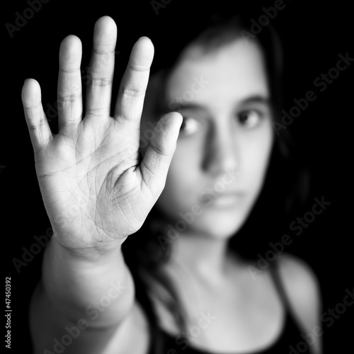 Photo: Girl with a hand signaling to stop in black and white Girl with a hand signaling to stop in black and white