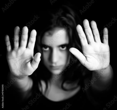 Photo: Girl with hands signaling to stop in black and white Girl with hands signaling to stop in black and white