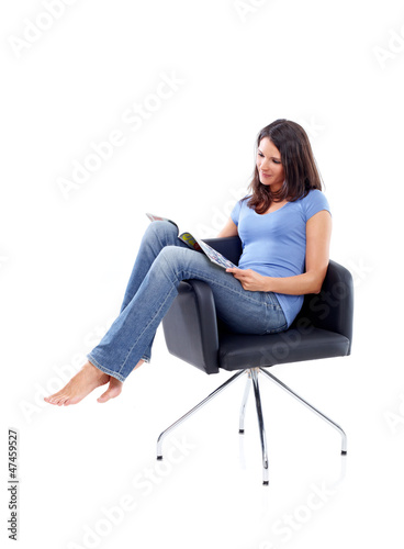 Photo: Casual 20s women sitting and reading in a magazine Casual 20s women sitting and reading in a magazine