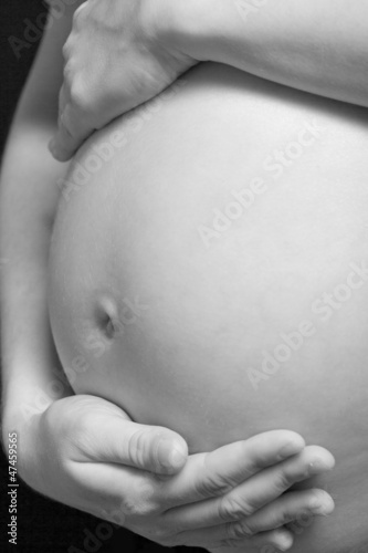 Photo: Closeup of a pregnant woman in black and white Closeup of a pregnant woman in black and white