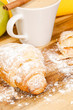 Breakfast concept with coffee and croissant