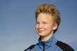 Teenager against blue sky background