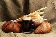 tankard of kvass and rye breads with ears, on burlap background