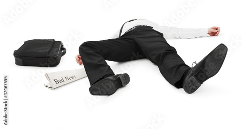 Photo: Businessman unconscious because of bad news Businessman unconscious because of bad news