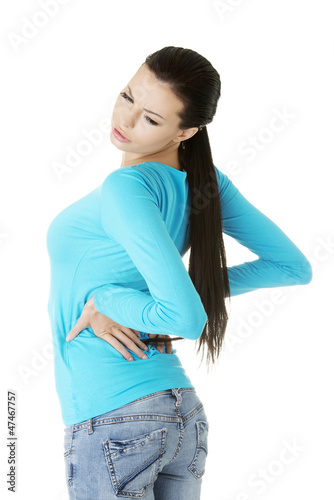 Photo: Young woman with backache Young woman with backache