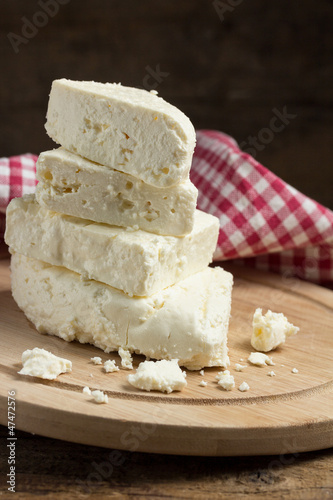 Photo: Still life with white cheese on wooden board Still life with white cheese on wooden board