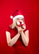 pretty blonde girl holding a christmas present is smiling