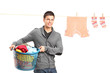 Smiling guy posing near a laundry line with clothes
