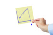 Hand holding paper with falling chart
