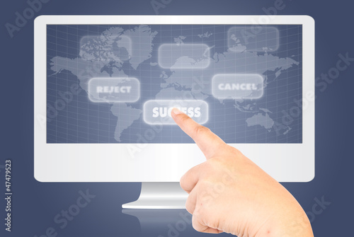 Photo: Hand touching button on monitor screen. Hand touching button on monitor screen.