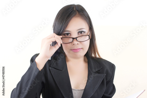 Photo: Business lady thinking with her work. Business lady thinking with her work.