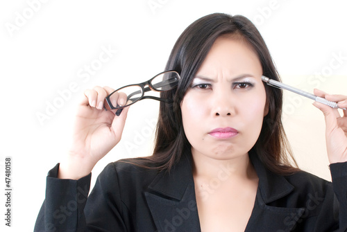 Photo: Business lady thinking with her work. Business lady thinking with her work.
