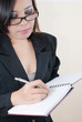 Business lady write on the notebook.