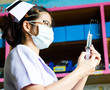 Nurse with medical syringe