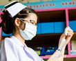 Nurse with medical syringe