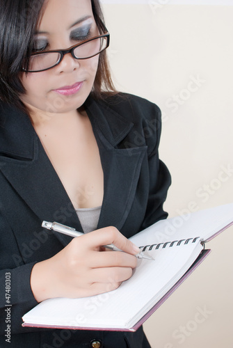 Photo: Business lady write on the notebook. Business lady write on the notebook.