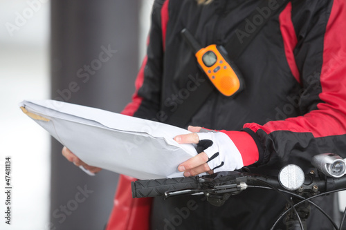 Photo: Female Cyclist Holding Courier Package Female Cyclist Holding Courier Package
