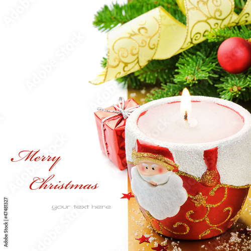 Photo: Red Christmas candle on festive background Red Christmas candle on festive background