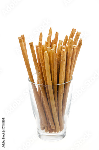Photo: Bread sticks with salt in a glass beaker isolated Bread sticks with salt in a glass beaker isolated