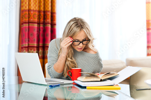 Photo: woman working on laptop at home woman working on laptop at home